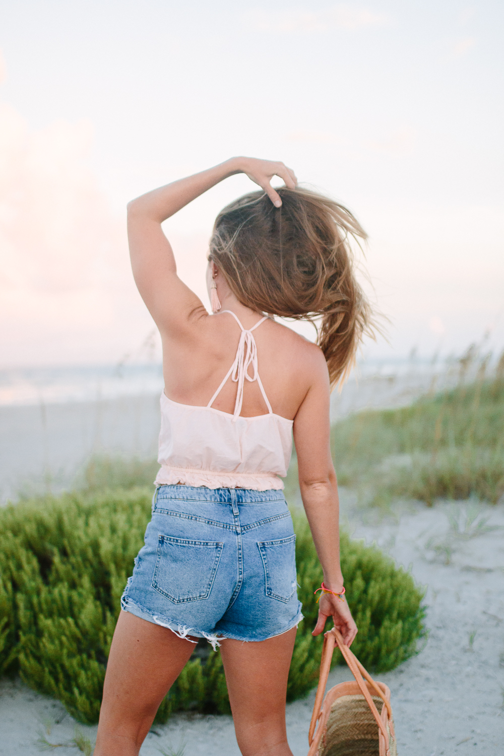 What to Wear to the Beach: A Casual Summer Outfit featuring an Aerie Crop Top, H&M High Waist Denim Shorts and Straw Beach Bag