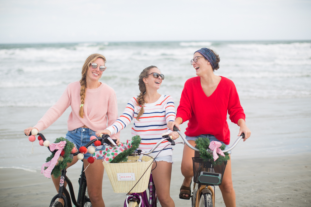 Sweaters to Wear During the Holiday Season | Beach Bike Ride | Winter Outfit Ideas | Christmas in Florida | Beach Bike Ride | Cropped Pink Sweater | Twisted Back Sweater | Red Knit Sweater | Striped Sweater | Friends on a Bike Ride