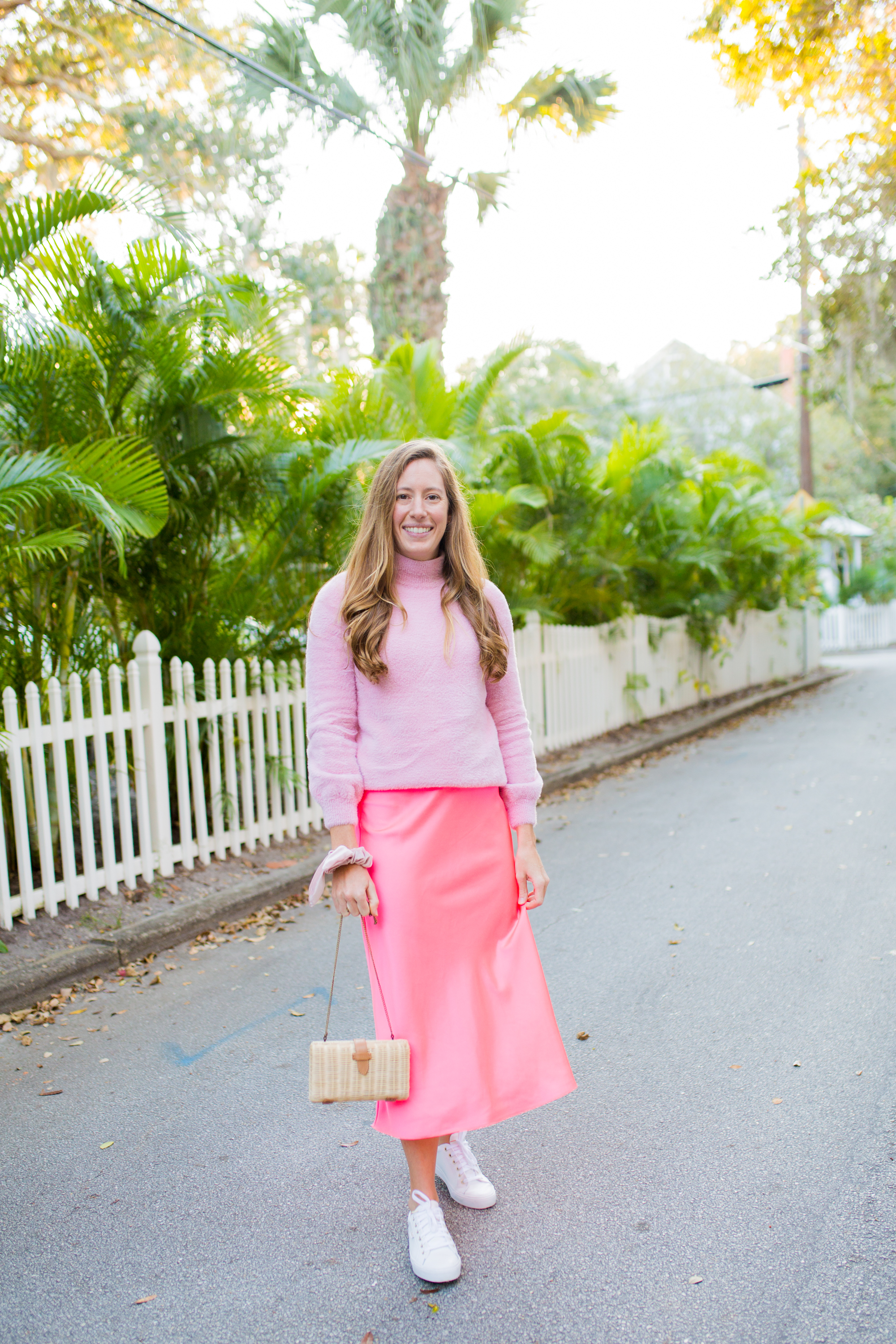 Colorful Monochromatic Winter Outfit / Winter Brights outfit / pink monochromatic outfit / bright colored outfits / pop of color outfits / silk slip skirt / white sneakers / valentines day outfit / straw bag - Sunshine Style, A Florida Fashion and Lifestyle Blog 